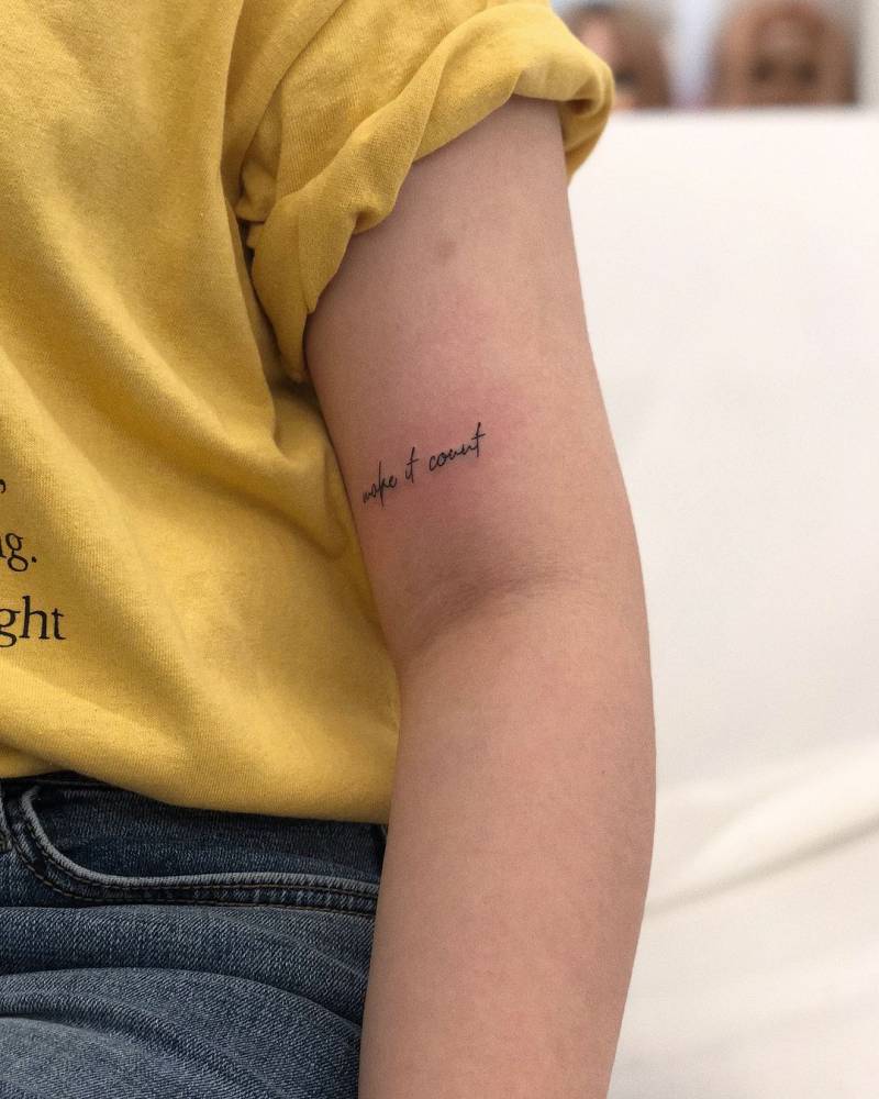 "Make it count" lettering tattoo located on the bicep.
