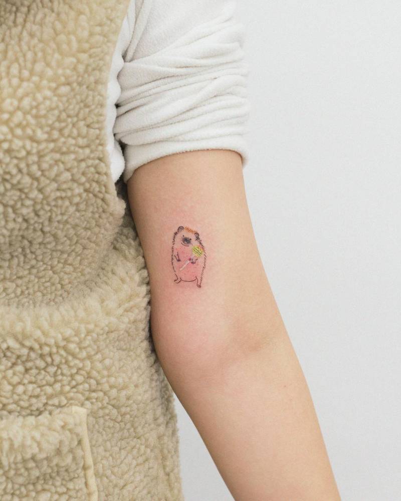 Watercolor style hedgehog tattoo done on the inner arm.