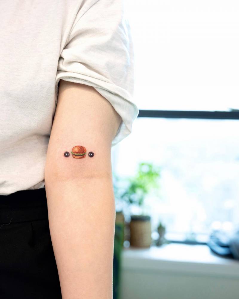 Hamburger and Soot Sprites tattooed on the bicep.