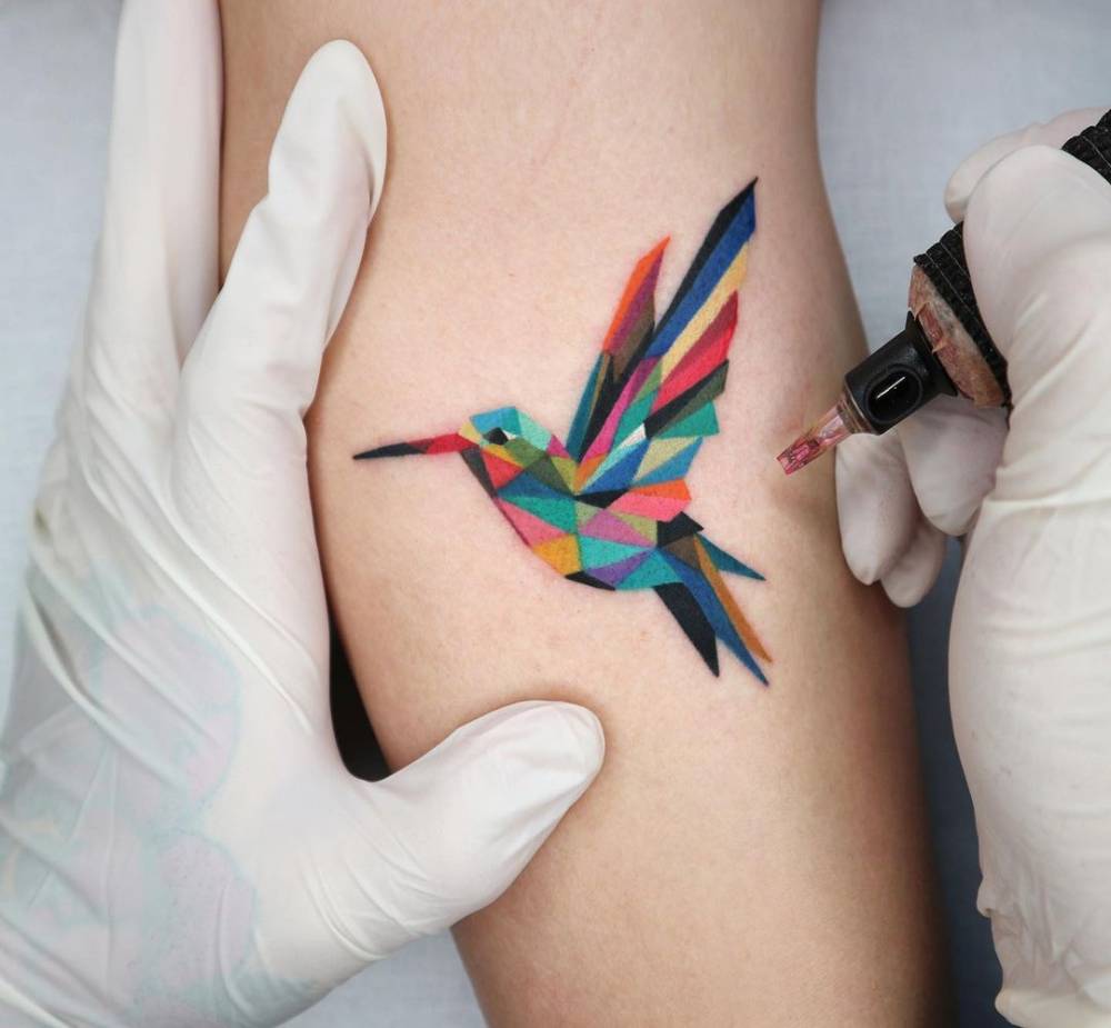Hummingbird tattoo done on the upper arm.