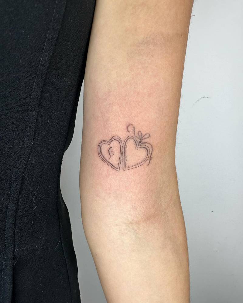 FIne line style pendant tattoo located on the inner arm.