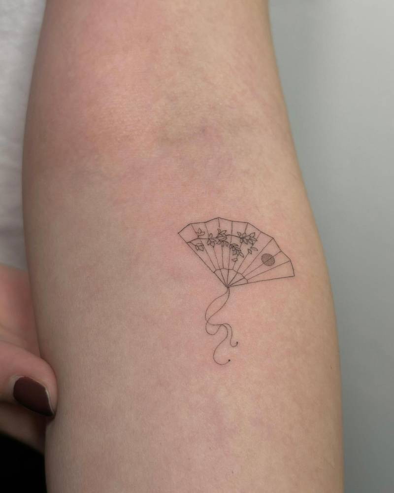 Single needle hand fan tattoo located on the inner forearm.