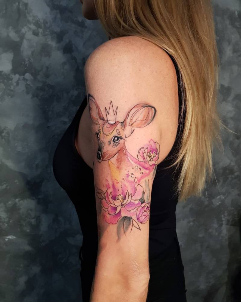 Sketch work deer and peony tattoo located on the upper arm.