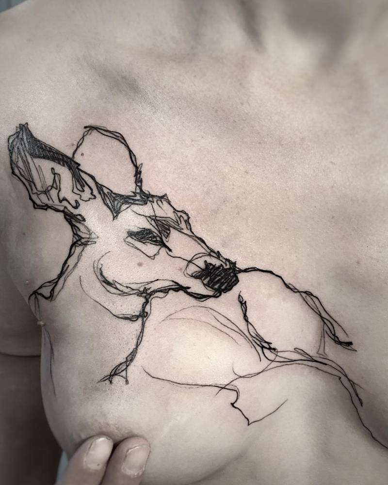 Sketch work deer portrait tattoo located on the chest.