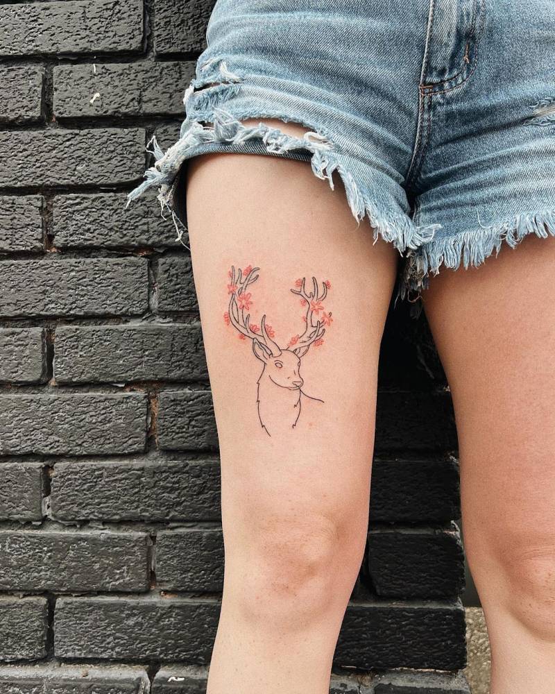 Hand poked deer portrait tattoo located on the thigh.