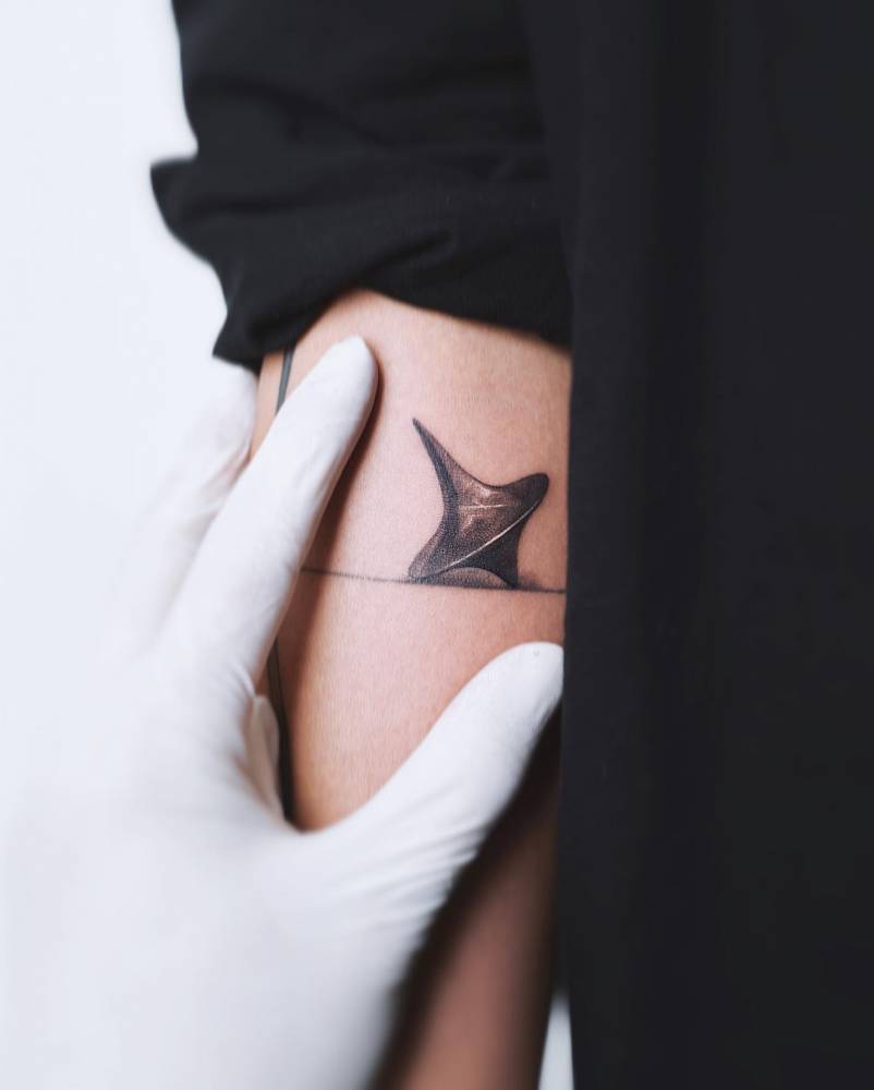 Micro-realistic Inception's spinning top tattoo done on the inner forearm.