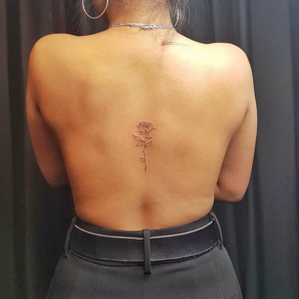 Fine line rose tattoo done on the back.