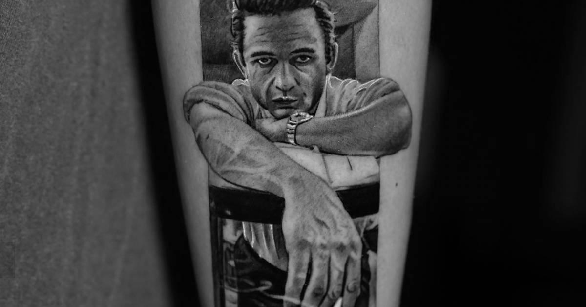 Johnny Cash portrait tattoo located on the forearm,