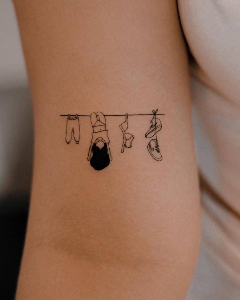 Clothes line tattoo located on the bicep.