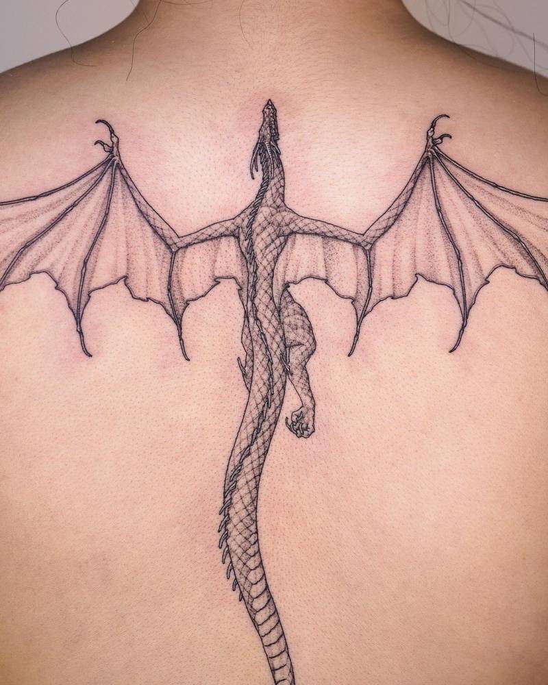 Ascending dragon tattooed on the back, illustrative style.