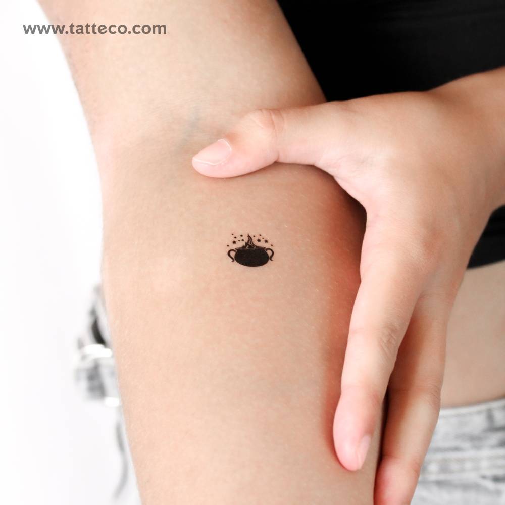 Blackwork style cauldron temporary tattoo placed on the inner forearm.