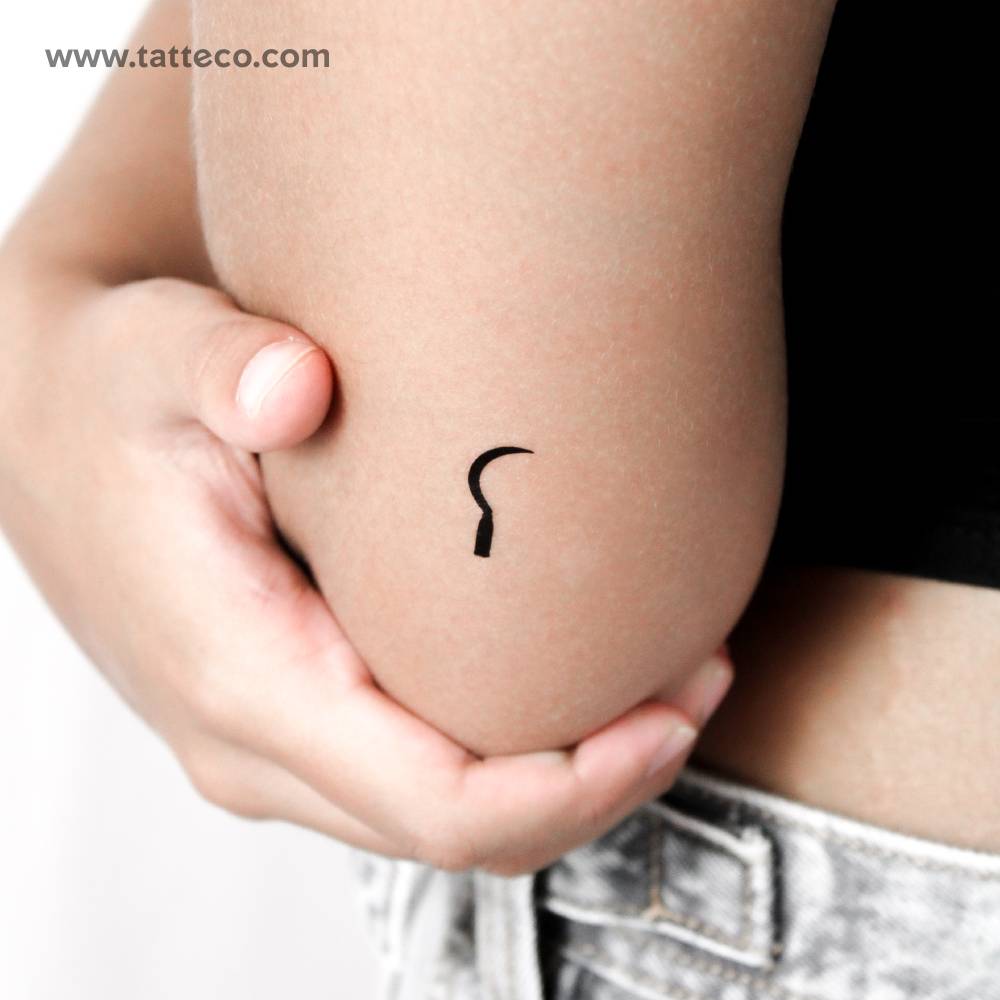 Minimalistic sickle temporary tattoo located on the tricep.