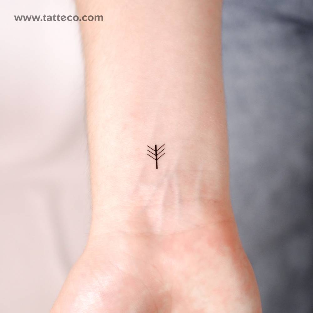 Little minimalistic beltane symbol temporary tattoo located on the wrist.