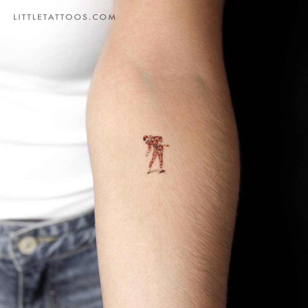 Harlequin temporary tattoo in illustrative style done on the inner forearm.