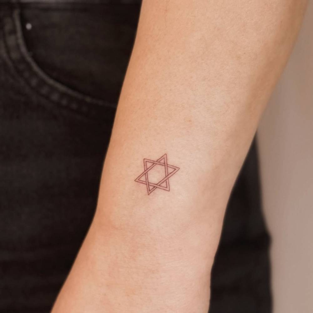 Little Star of David tattoo located on the wrist.