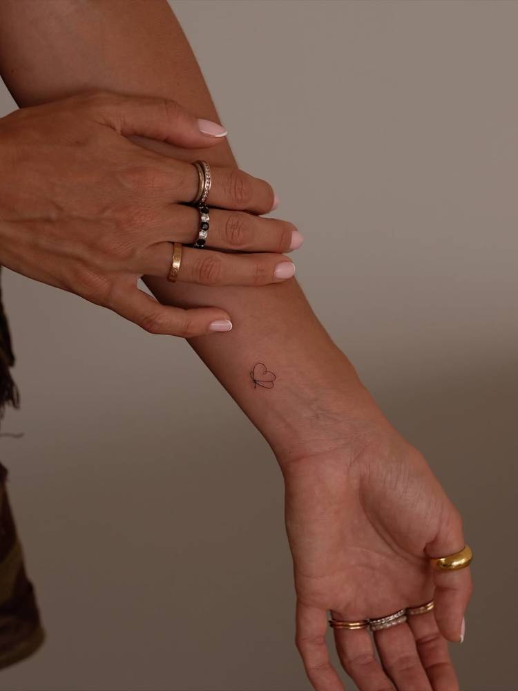 Fine line style mini butterfly tattoo done on the wrist.