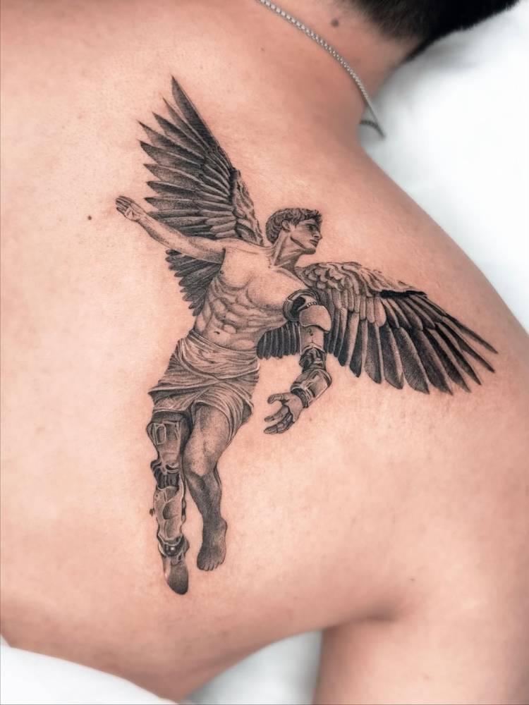 Icarus tattoo in micro-realistic style located on the shoulder blade.