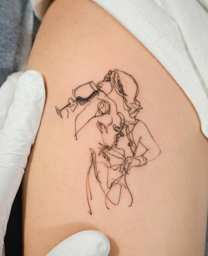 Woman drinking wine tattoo in sketch work style.