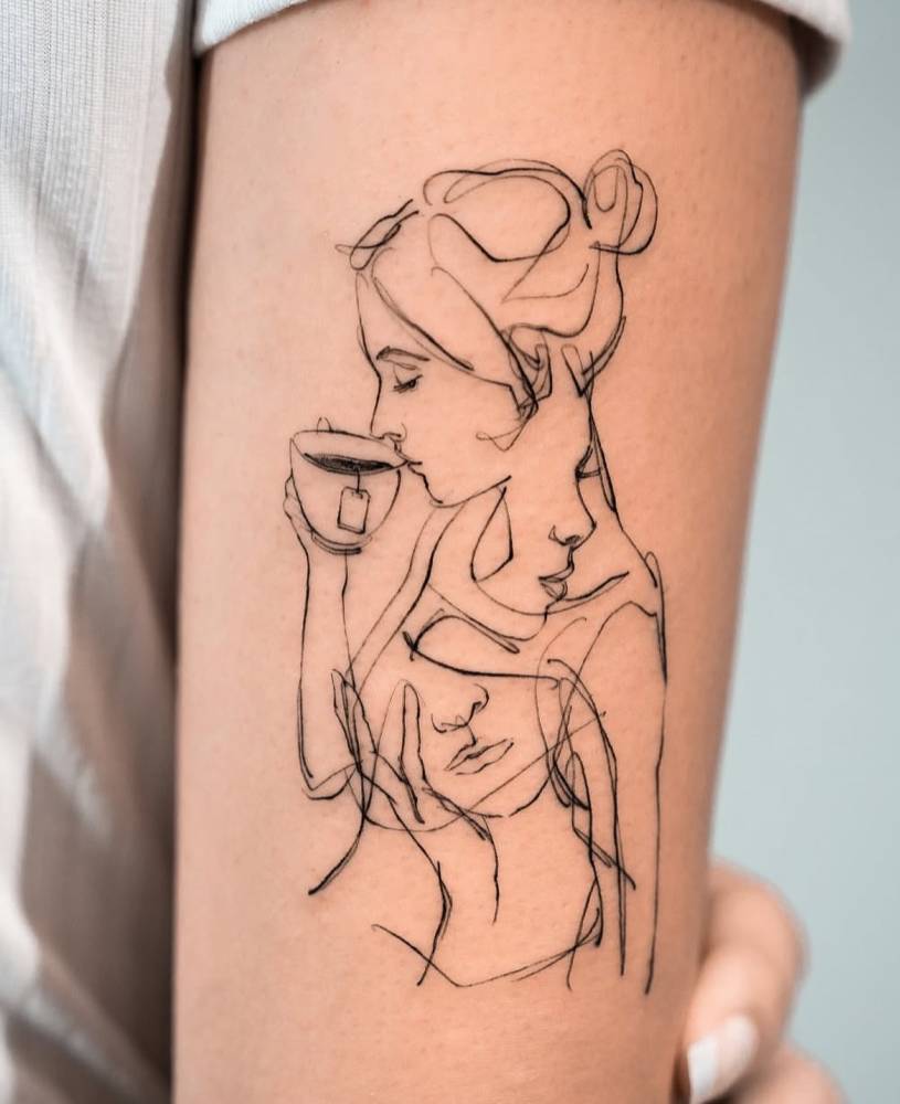 Woman drinking tea tattoo in sketch work style done on the tricep.