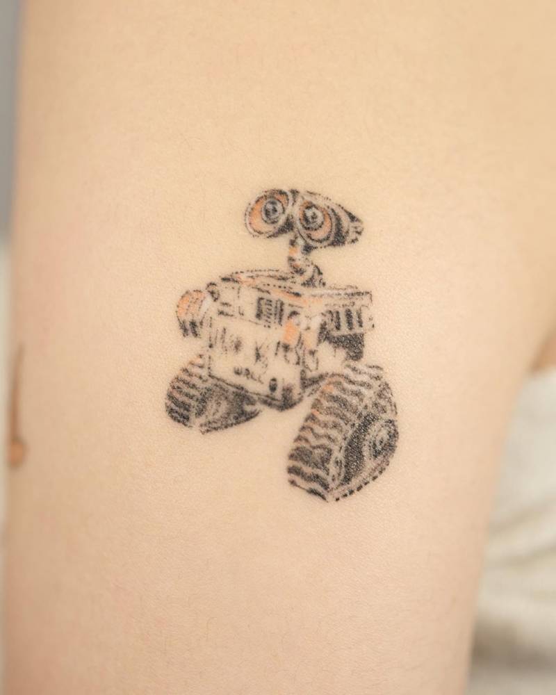 Dotwork style WALL-E tattoo located on the upper arm.