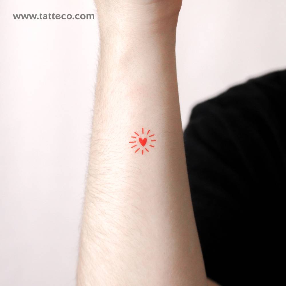 Sparkling heart temporary tattoo located on the wrist.