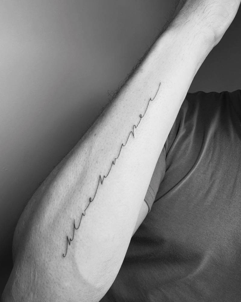 Handwritten font name "Chloe Harper" tattoo located on the forearm.