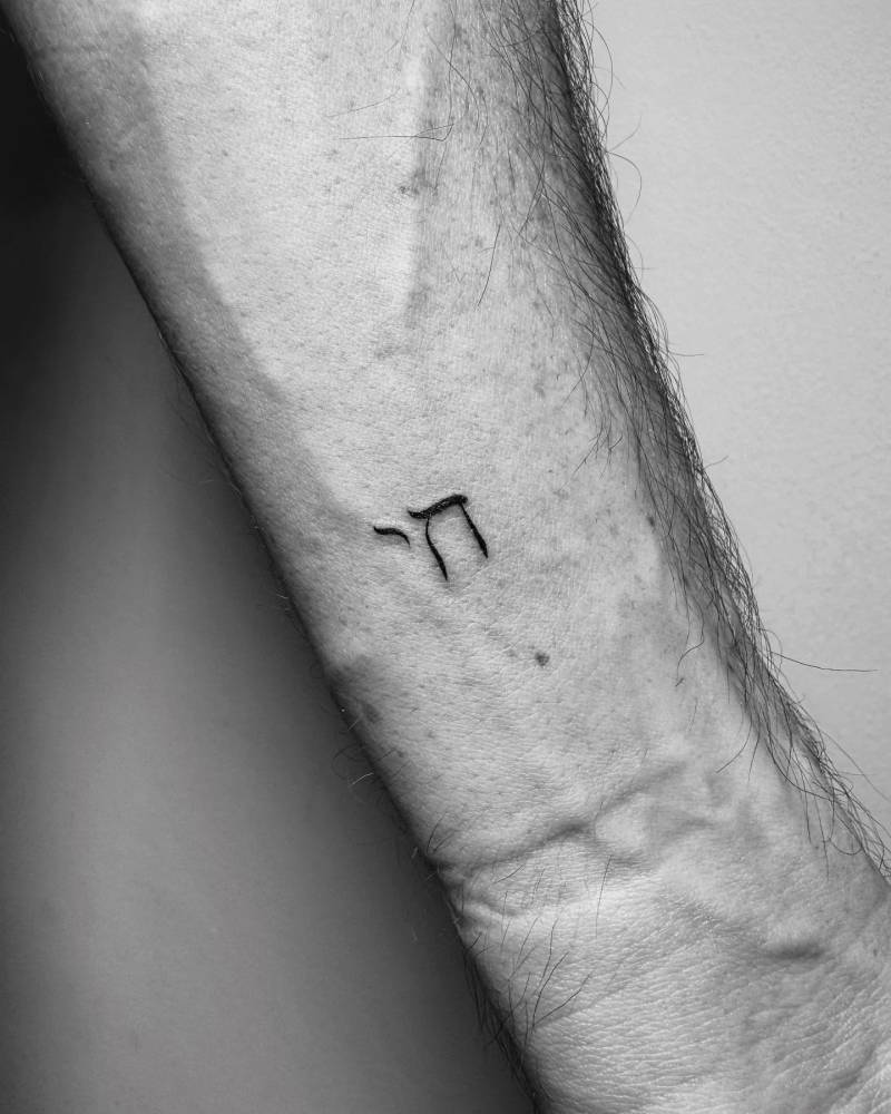 Chai tattoo in minimalistic style located on the wrist.
