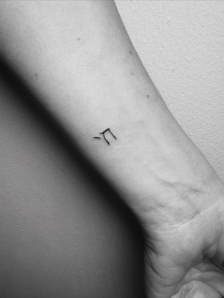 Chai tattoo in minimalistic style located on the wrist.