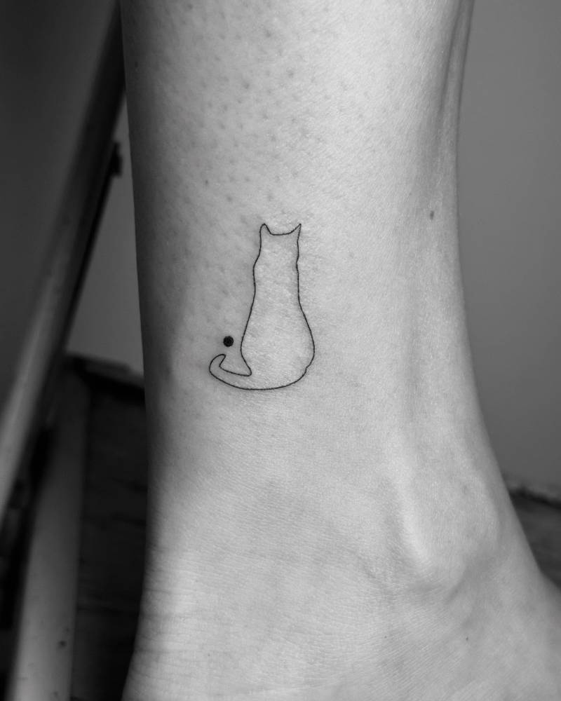 Minimalistic style cat tattoo done on the ankle.