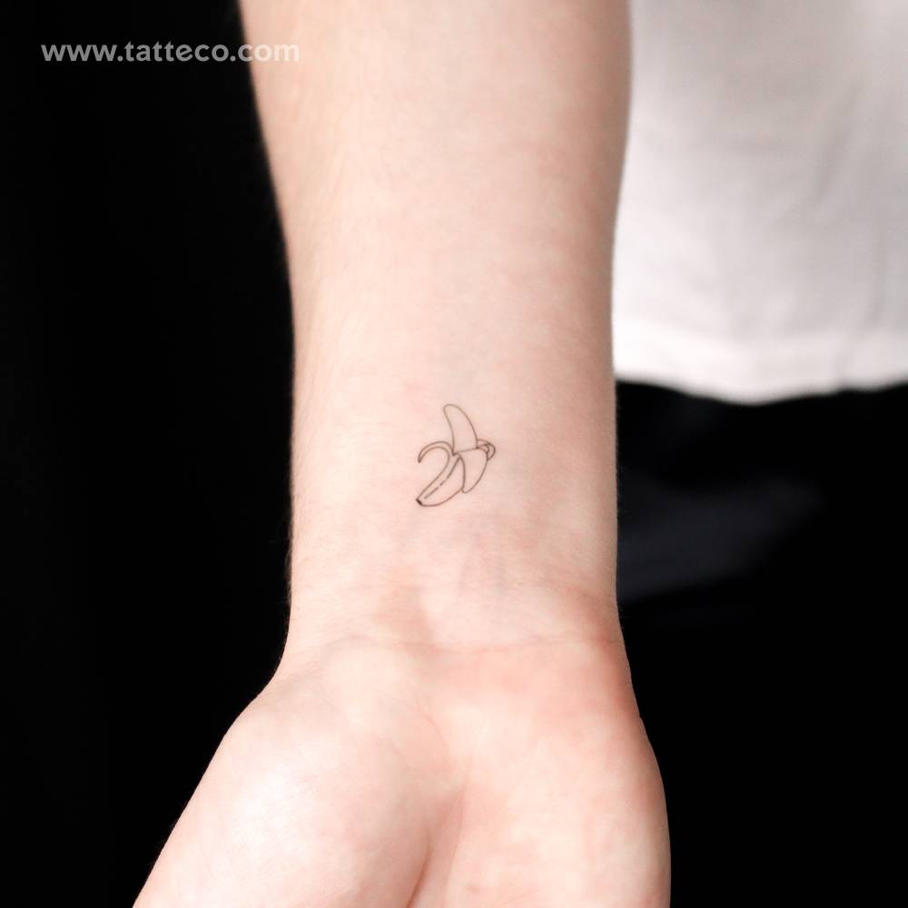 Fine line style banana semi-permanent tattoo located on the wrist.
