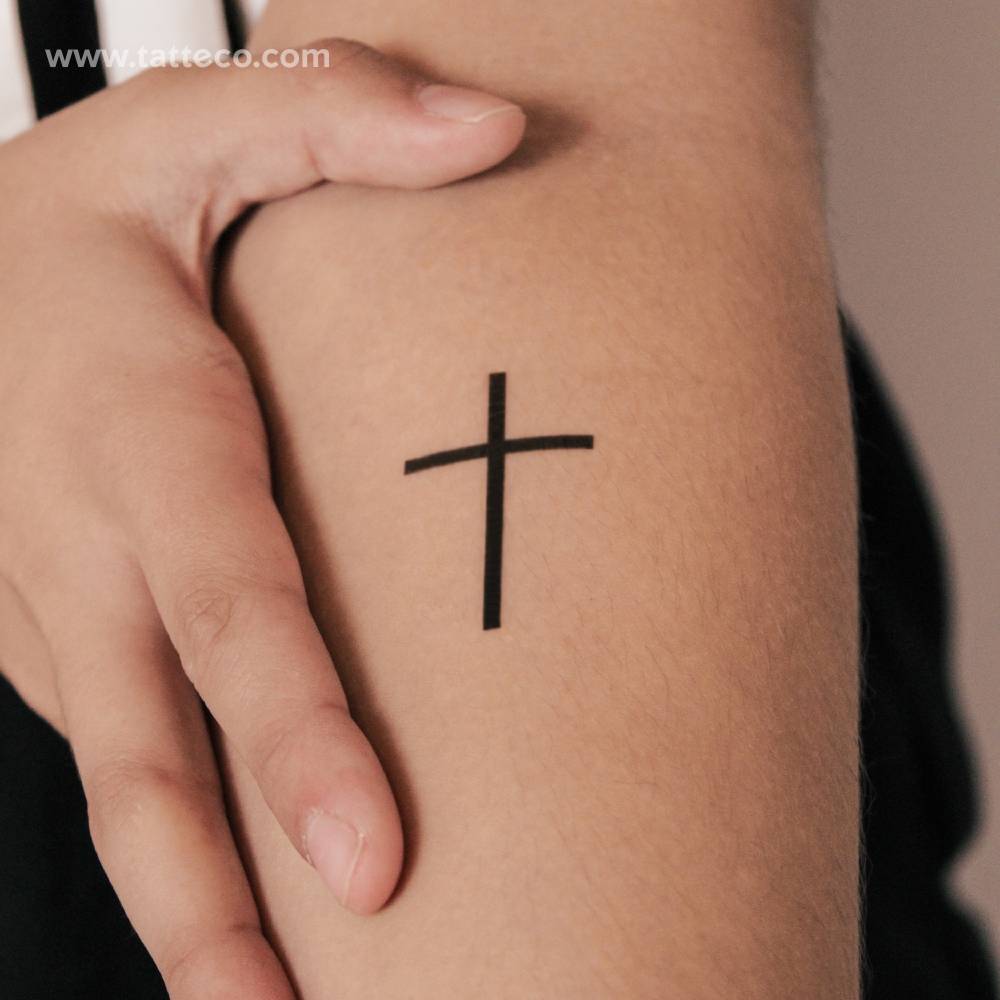 Blackwork style cross semi-permanent tattoo located on the inner forearm.