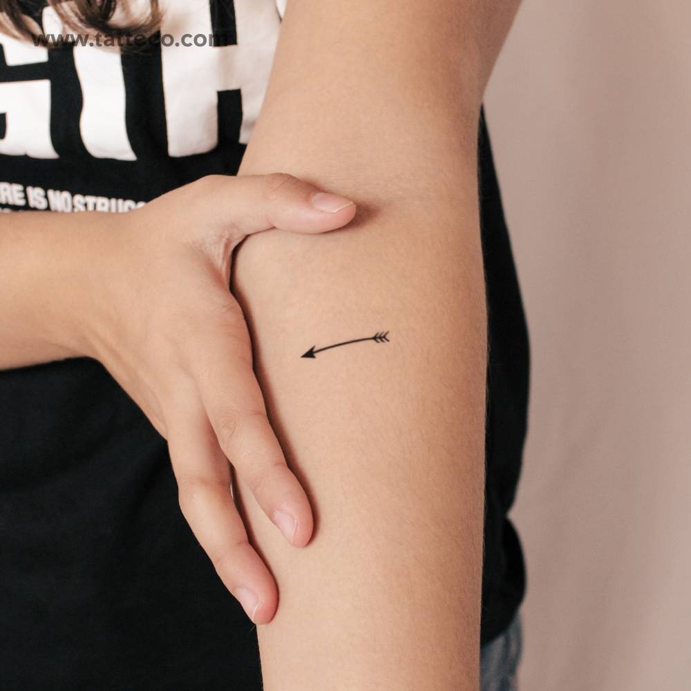 Minimalistic arrow semi-permanent tattoo located on the inner forearm.