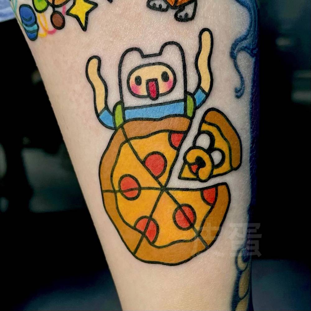 Finn the Human and Jake the Pizza tattoo located on the inner forearm.