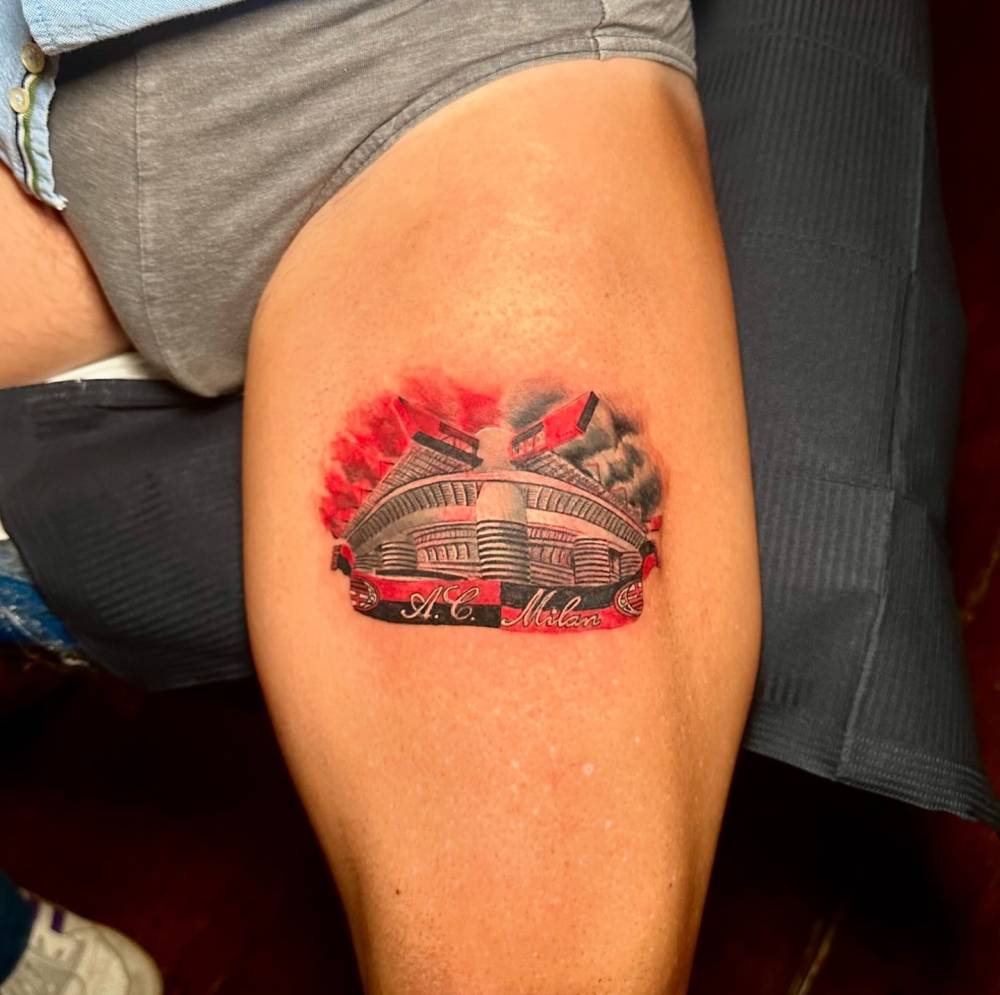 San Siro tattoo located on the thigh, micro-realistic style.