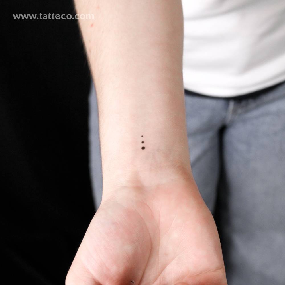 Three tiny gradual dots semi-permanent tattoo done on the wrist.