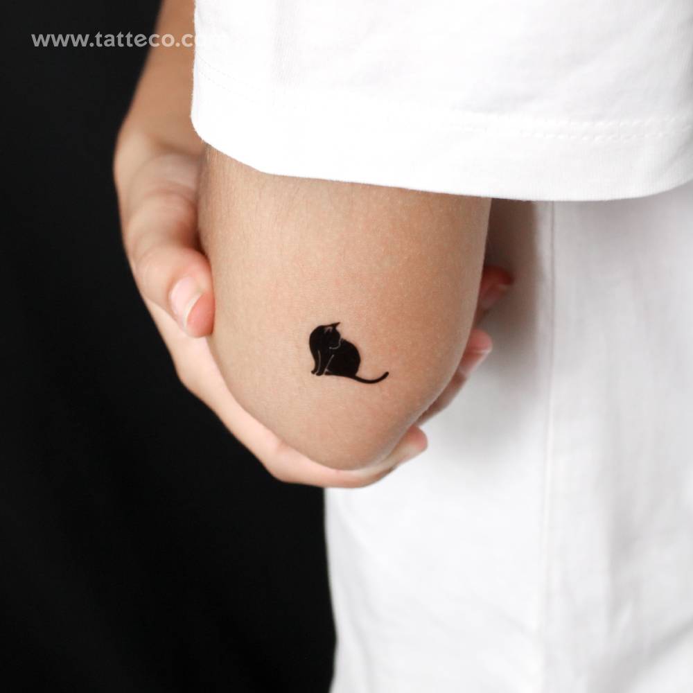 Standing black cat semi-permanent tattoo located on the tricep.