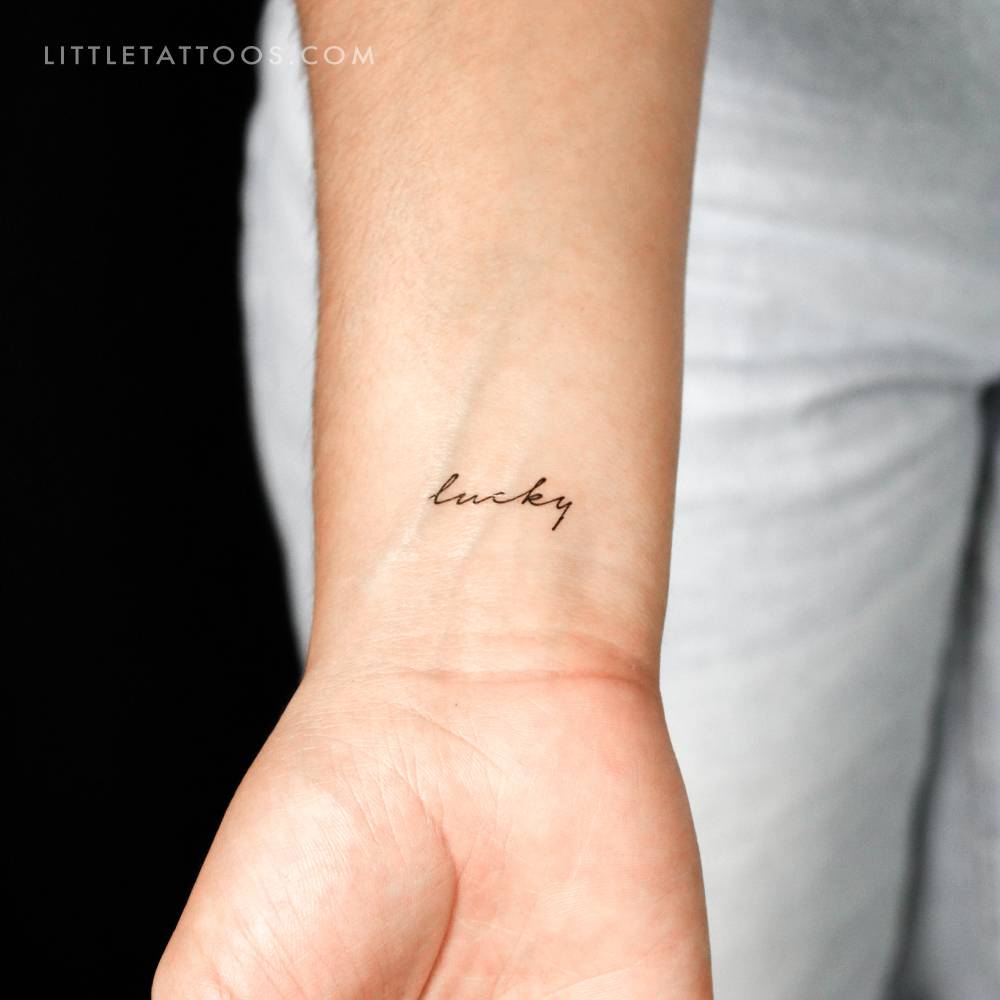 Handwritten 'lucky' temporary tattoo.
