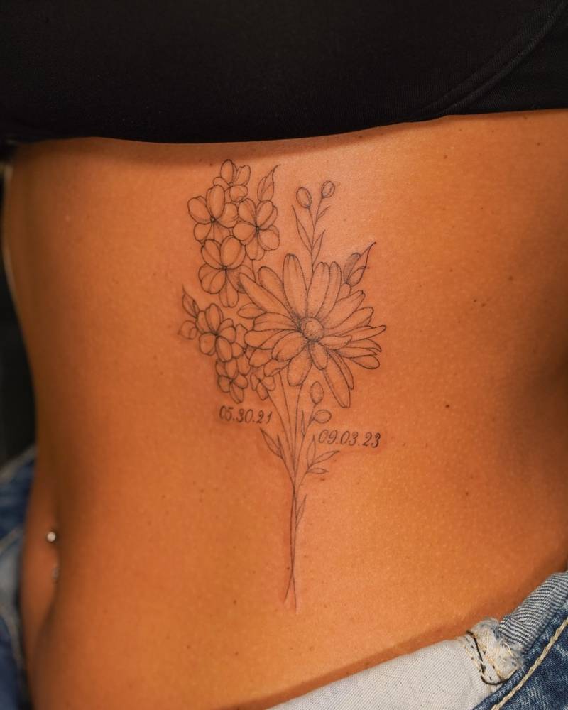 Flower bouquet tattoo in fine line style located on the waist.