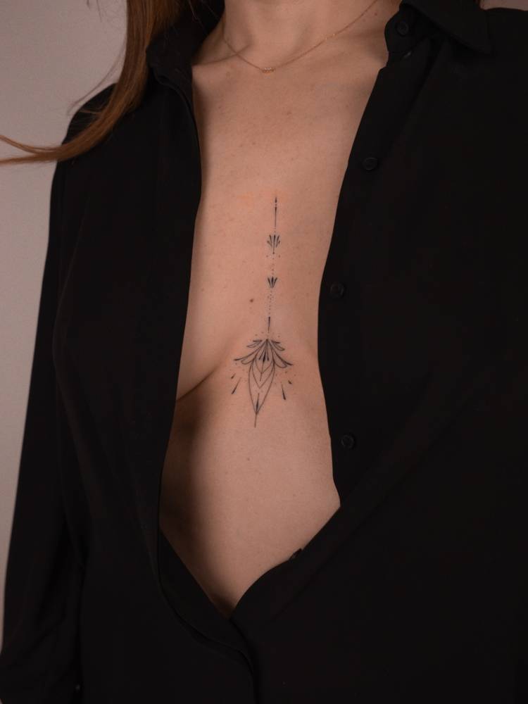 Ornamental tattoo hand poked on the sternum.