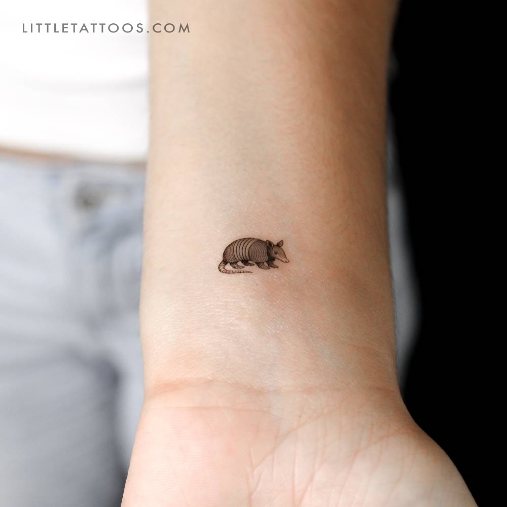 Armadillo temporary tattoo in illustrative style located on the wrist.