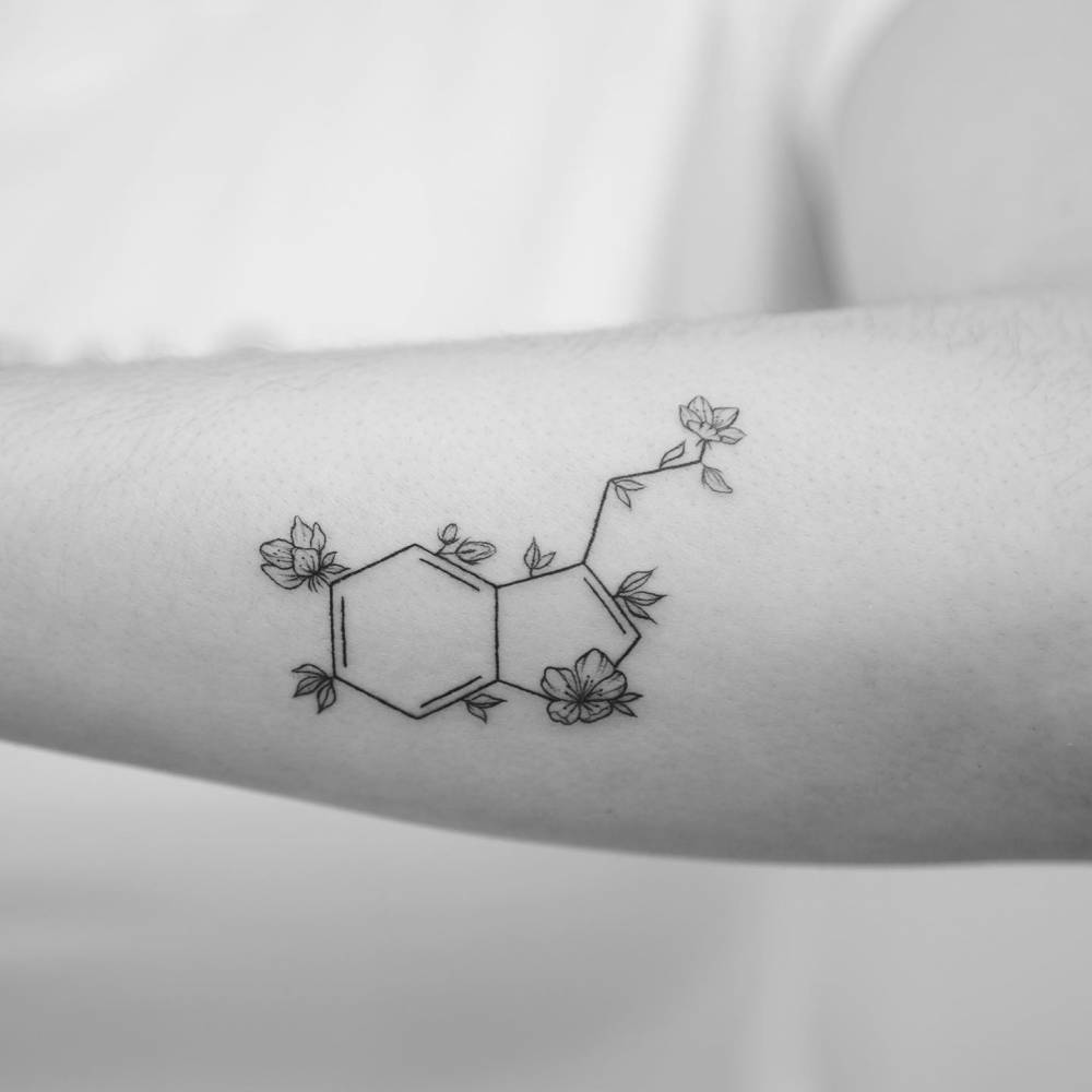 Serotonin chemical structure tattoo located on the inner forearm.