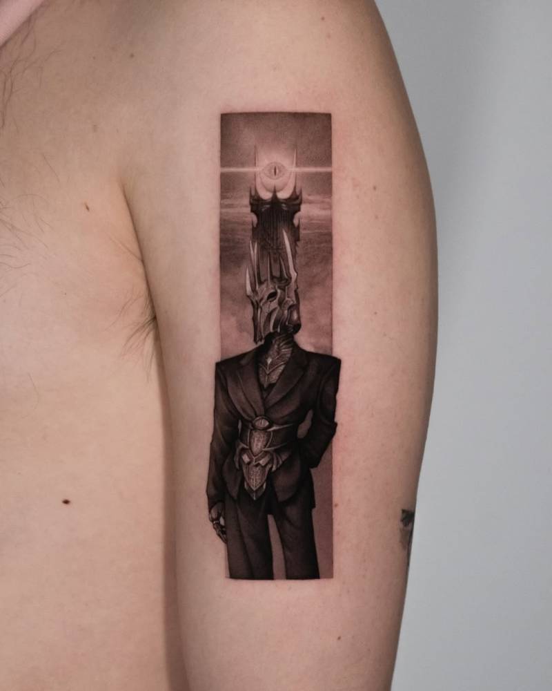 Sauron tattoo located on the upper arm, micro-realistic style.
