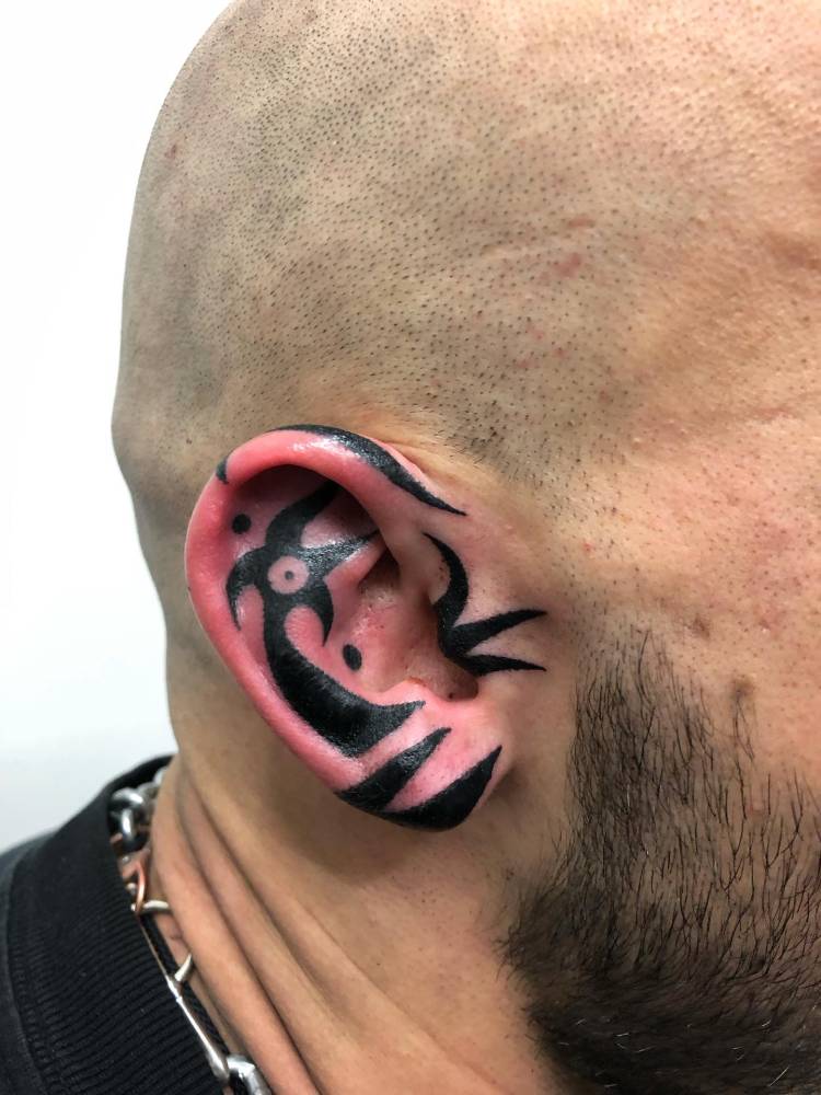 Tribal design tattooed on the ear.