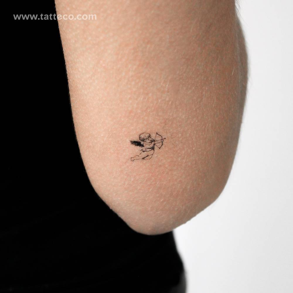 Little cupid temporary tattoo located on the tricep.