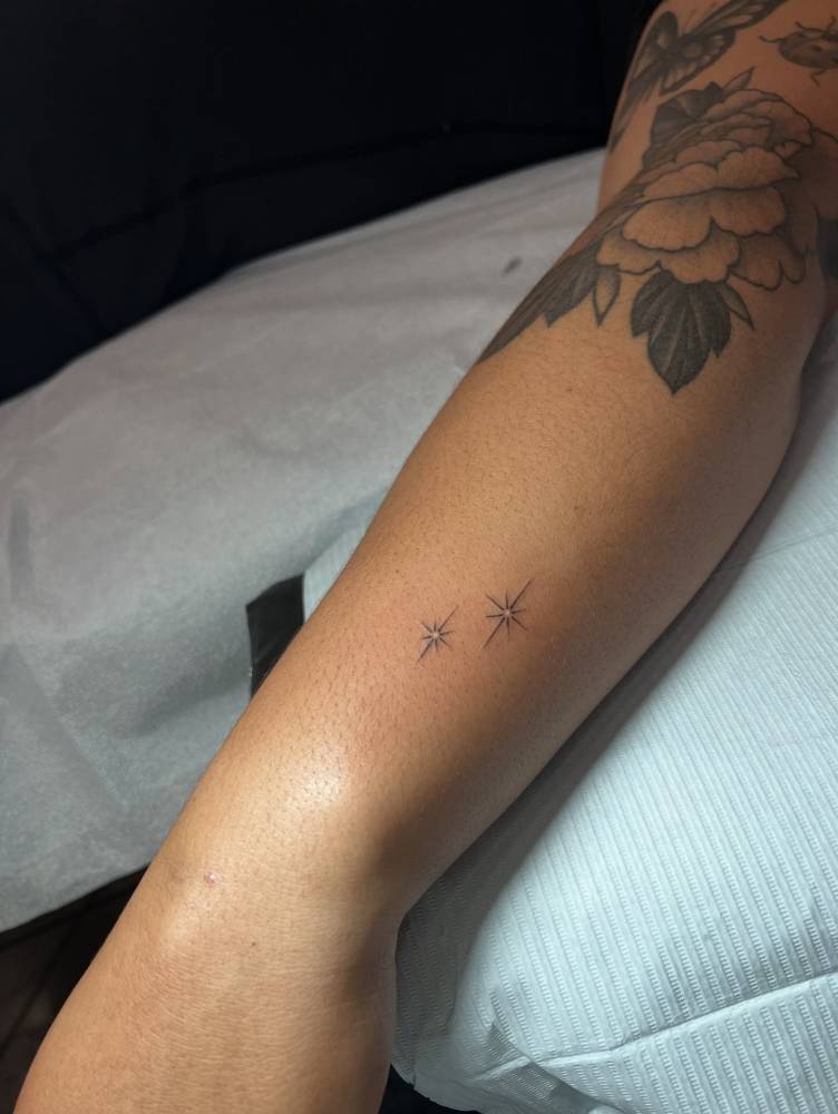 Sparkling star couple tattoo in minimalistic style.