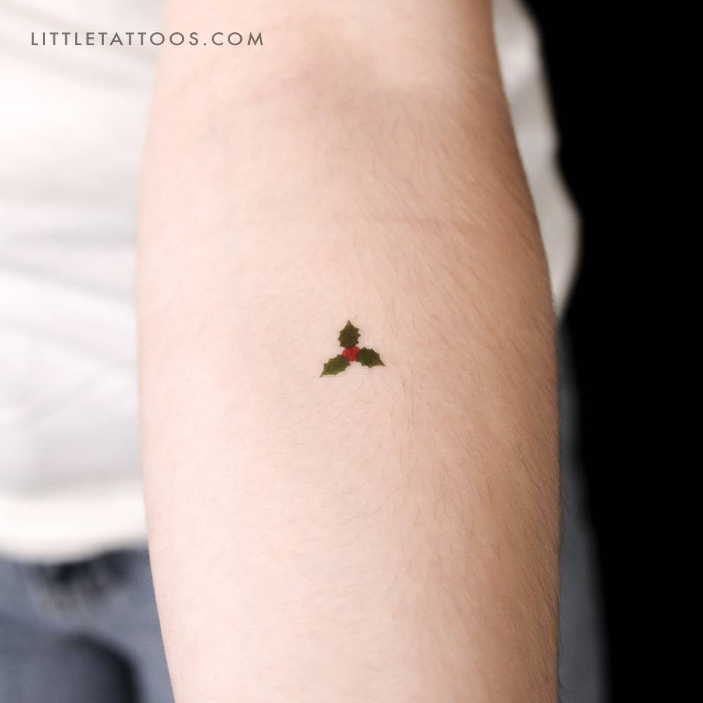 Holly flower temporary tattoo located on the inner forearm.