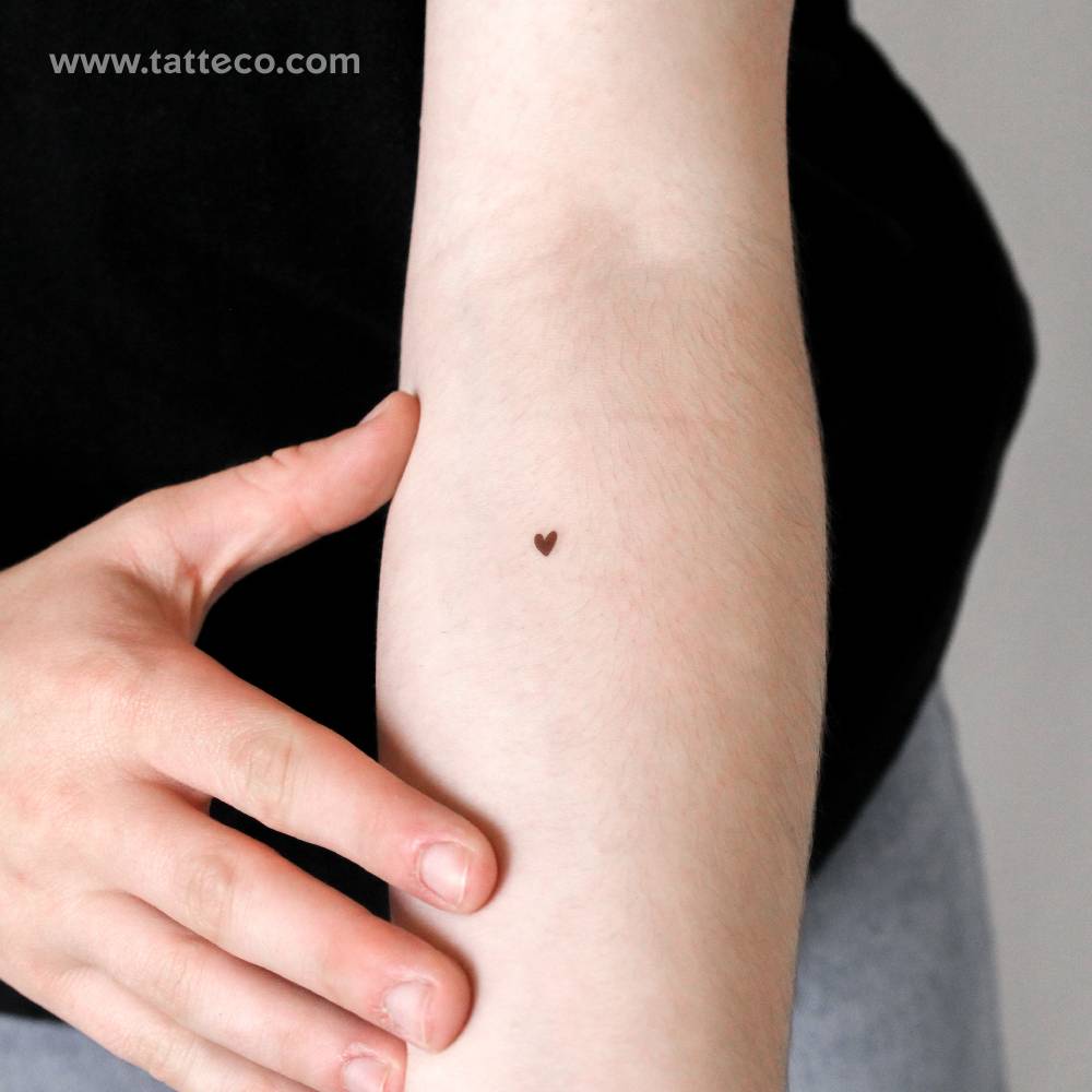 Hand-drawn brown heart temporary tattoo located on the inner forearm.