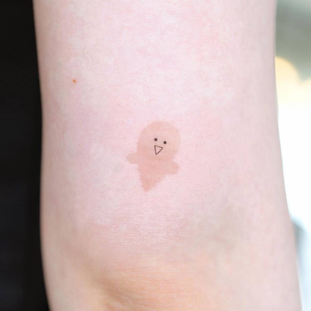 Birthmark cover up tattoo on the tricep.