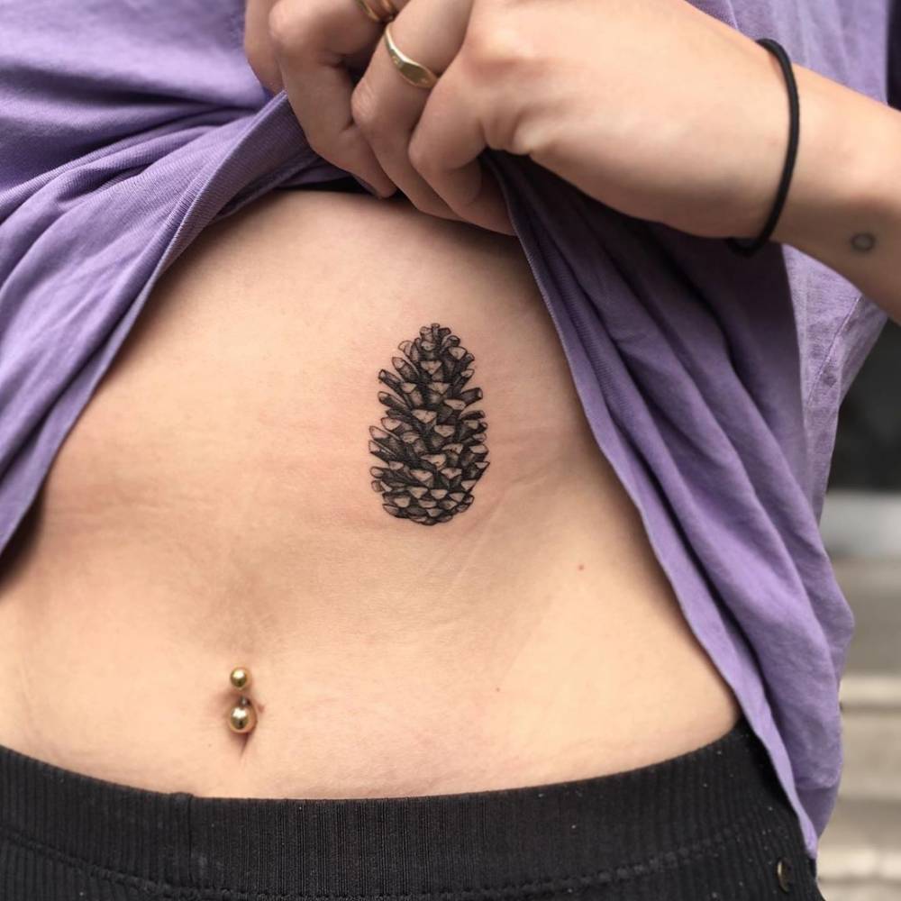 Pine cone tattoo on rib