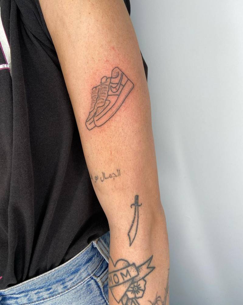 Hand-poked Nike Air Force 1 shoe pair tattoo